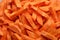 Chopped carrot full frame closeup. Vegan food background. Carrot sticks. Food preparation.