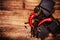 Chopped Chocolate Bar with Red Chilli Pepper on wooden background closeup. Chunks of Broken dark chocolate bar on wood table