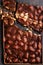 Chopped chocolate over black background top view with copyspace