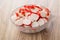 Chopped crab sticks in glass bowl on table