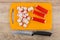 Chopped crab sticks on plastic cutting board and knife