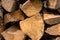 Chopped firewood for a fire stacked chaotically pine, nut, mulberry background texture