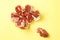 Chopped fruit. Pomegranate slices. Small red grains. Yellow background