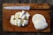 Chopped and halved mozzarella, wooden desk and knife