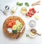 Chopped ingredients for avocado salsa, guacamole  or salad on cutting board. Fresh cut avocado, tomatoes , lemon, lime , olives