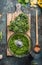 Chopped kale leaves for salad making or cooking on wooden cutting board with spoon on rustic background , top view, place for text