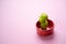 Chopped leek and stacked in bowl on light pink smooth cardboard surface