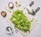 Chopped lettuce with knife for herbs, Mortar Pepper on a cutting board with oil wooden rustic background top view close up