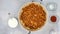 Chopped marinated chicken meat close up on frying pan, and some ingredients for sour cream chicken paprika recipe