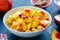 Chopped peaches and whole peache on a  table,  closeup