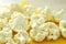 Chopped pieces of cauliflower on yellow cutting board