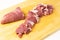 Chopped pieces of the most tender and soft pork meat on cutting board. Fresh and juicy pork tenderloin without fat for tasty bbq