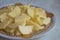 Chopped potatoes. In the chopped potato plate . Sliced, peeled raw potatoes on a board . Chopped potatoes in a bowl . Diced potato