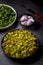 Chopped raw okra mixed with turmeric powder in a bowl, preparation for indian vegetable bhindi fry