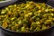 Chopped raw okra mixed with turmeric powder in a bowl, preparation for indian vegetable bhindi fry