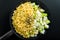 Chopped raw onion, corn, sliced zucchini, spice in vegetable oil in a frying pan