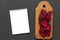 Chopped red beetroot on rustic wooden chopping board with notepad over black background, top view. Closeup. From above, overhead