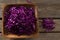 Chopped red cabbage in tray on wooden table