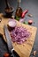 Chopped red Mars Onion on wooden cutting board at domestic kitchen