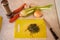 Chopped rosemary on a cutting board lies on the table next to vegetables