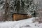 Chopped stacked and organized firewood set in a snowy forest pathway in early December Switzerland