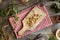 Chopped stinging nettle root on a wooden cutting board