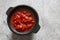 Chopped tomatoes cooked in a cast iron pot.