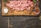 Chopped turkey breast salt and pepper and fork meat on a cutting board border ,place text on wooden rustic background t