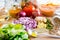 Chopped vegetables and spices on a wooden kitchen table