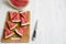 Chopped water melon on bamboo board on a white wooden surface, high angle. Summer food.