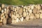 Chopped wood logs for sale use in fire place at home stored on forest woods green biomass energy