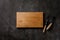 Chopping board and vintage knife, fork on dark concrete tabletop