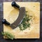 Chopping Fresh Rosemary with Mezzaluna Curved Knife on Board Top View