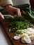 Chopping leeks on wooden chopping board