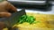 Chopping parsley on a wooden board. Video macro