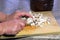 Chopping raw mushrooms on a wooden board.