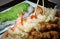 Chopstick over shrimp tempura in the table