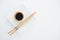 Chopstick and soy sauce on white plate