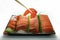 Chopsticks pinch fresh salmon sushi and wasabi