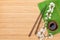 Chopsticks, sakura branch, soy sauce and bamboo mat