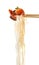 Chopsticks with tasty chinese noodles on white background