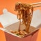 Chopsticks with tasty noodles from paper boxes