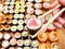 Chopsticks with tuna nori roll over lot of sushi