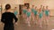 A choreographer teaches classical ballet in a dance Studio for young ballerinas.