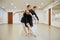 Choreographer works with young ballerina in class