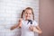 Chores for children. Girl splashes water on sponge