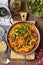 Chorizo and yellow split peas stew with tomatoes and padrones peppers