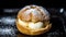 Choux au Craquelin: A display of choux pastry puffs, sugar-coated shells encasing cream filling