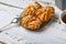 Choux pastry and spoon, on wooden background. Close Choux Cream. With a metal spoon and fork on the background