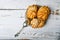 Choux pastry and spoon, on wooden background. Close Choux Cream. With a metal spoon and fork on the background